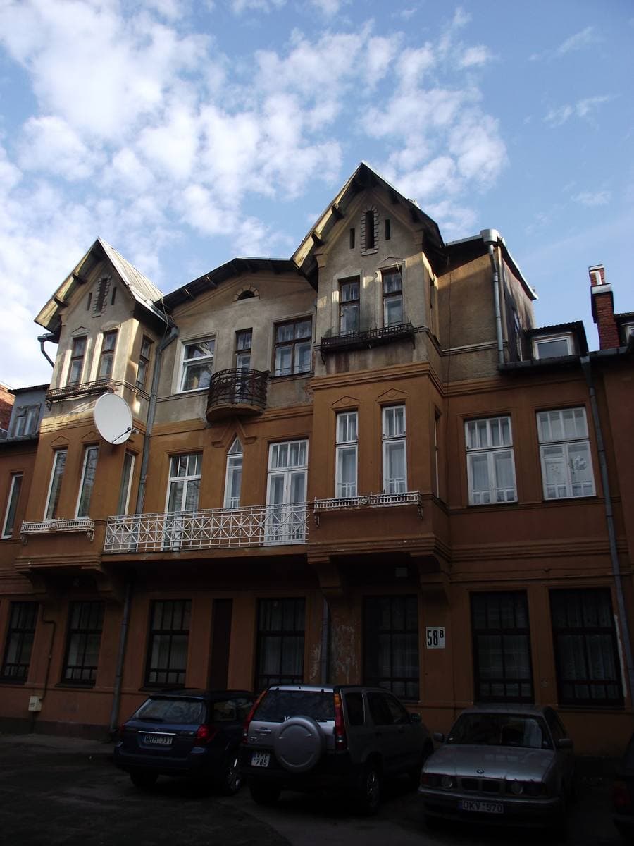 An ochre nineteenth-century building with a corner balcony on Kęstučio Street