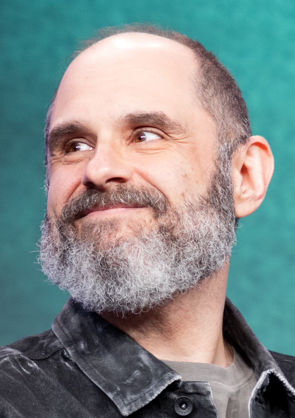 Craig Mazin, bearded, smiling to one side