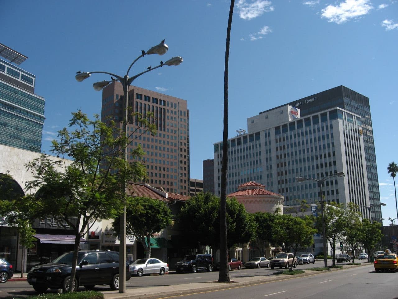 Office towers and low shops on a sunny street in Westwood