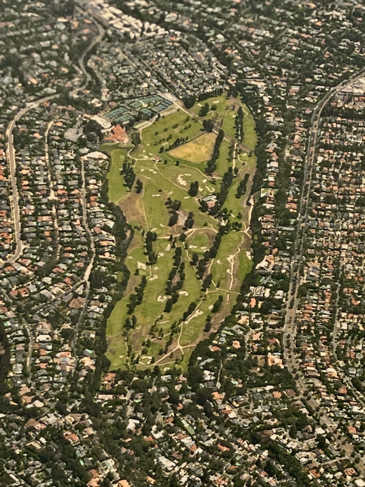 Riviera Country Club’s green fairways among the houses of Pacific Palisades, seen from a plane