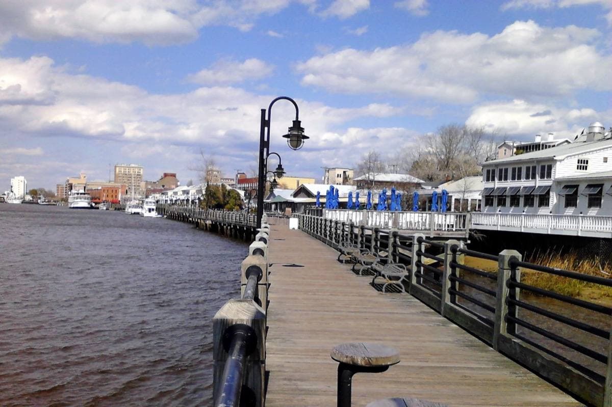 The Wilmington Riverwalk boardwalk with downtown buildings behind it