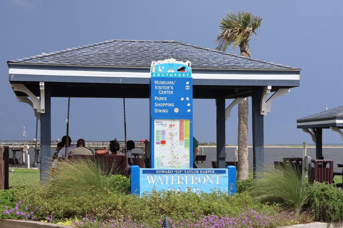 A waterfront park with benches looking over the river at Southport