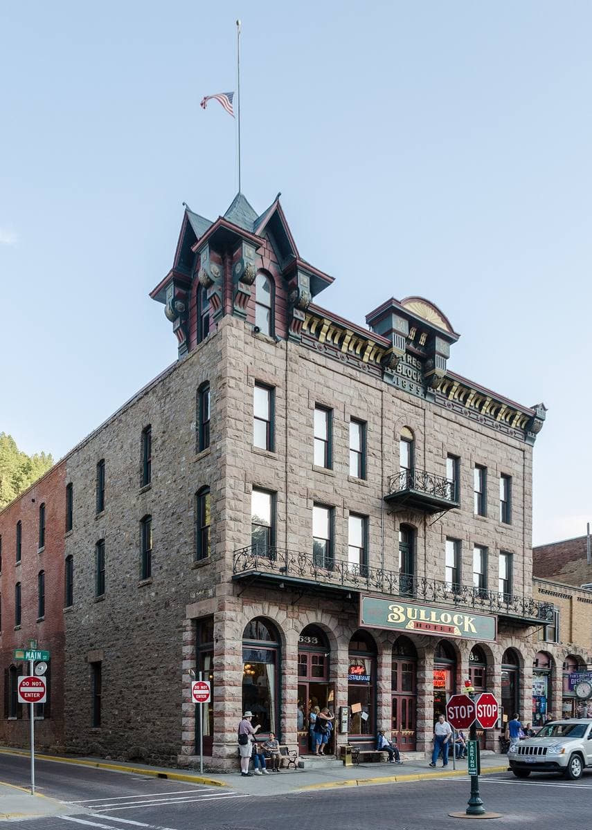The Bullock Hotel’s stone front and turret on a street corner