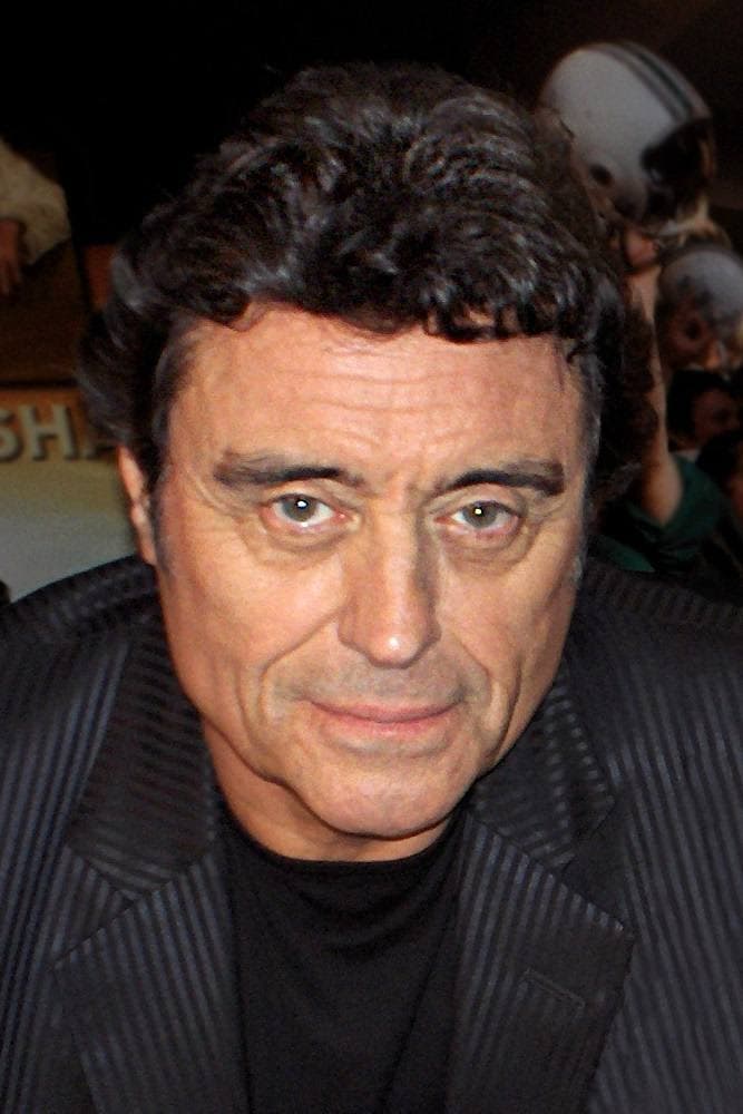 Ian McShane in close-up, dark hair, a faint smile