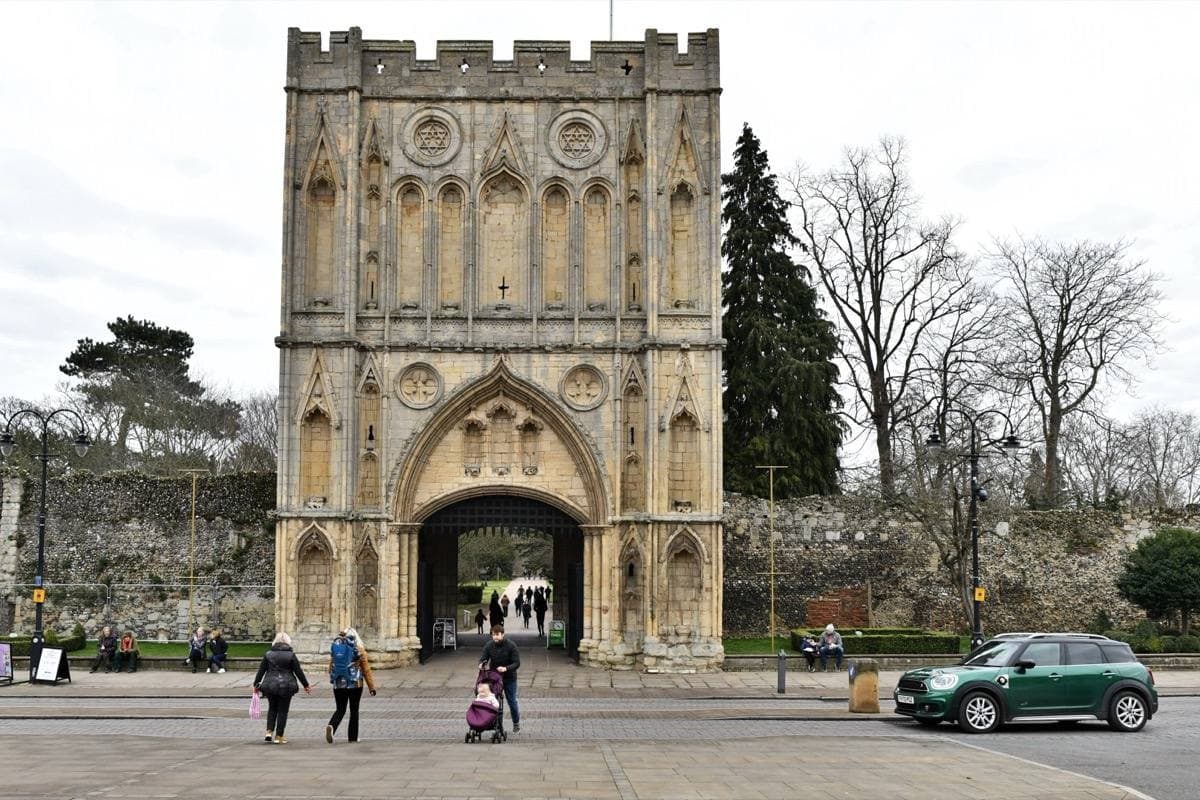 A tall medieval stone gateway with a pointed arch