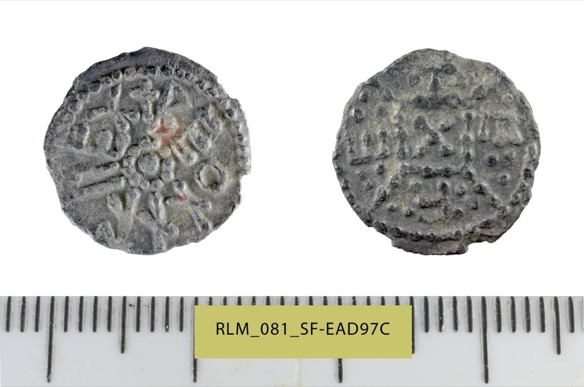 Both faces of a small worn silver coin with a beaded border and letters