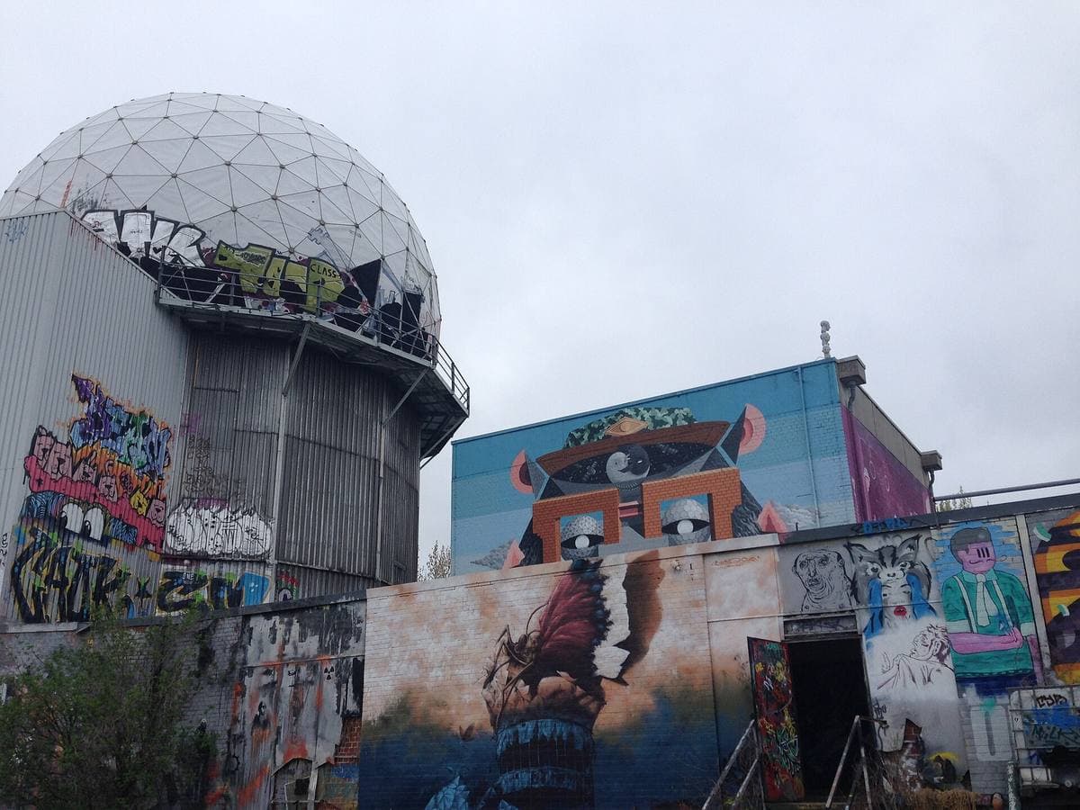 Radar domes and painted walls on top of a hill