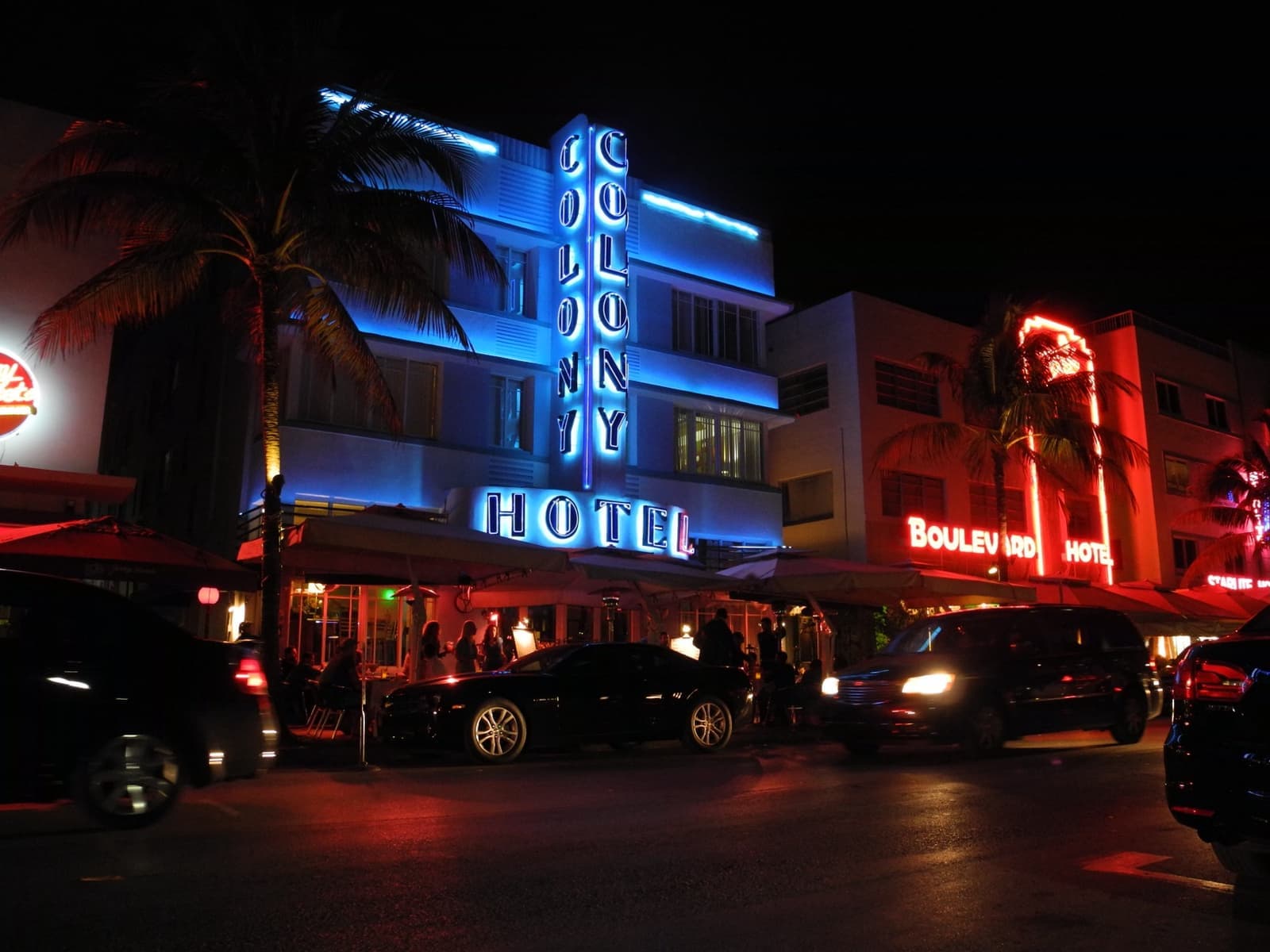 The Colony Hotel’s vertical blue neon sign at night on Ocean Drive