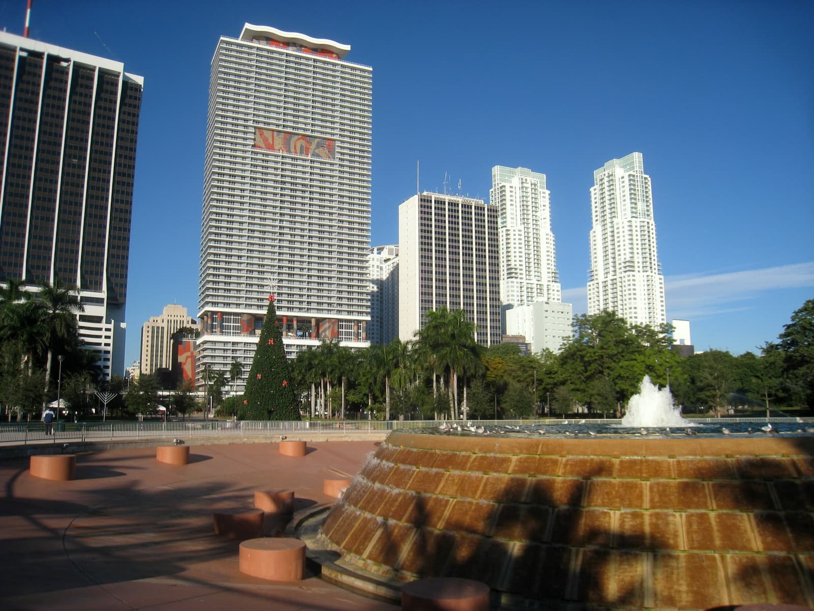 A round tiled fountain in Bayfront Park with downtown Miami towers behind