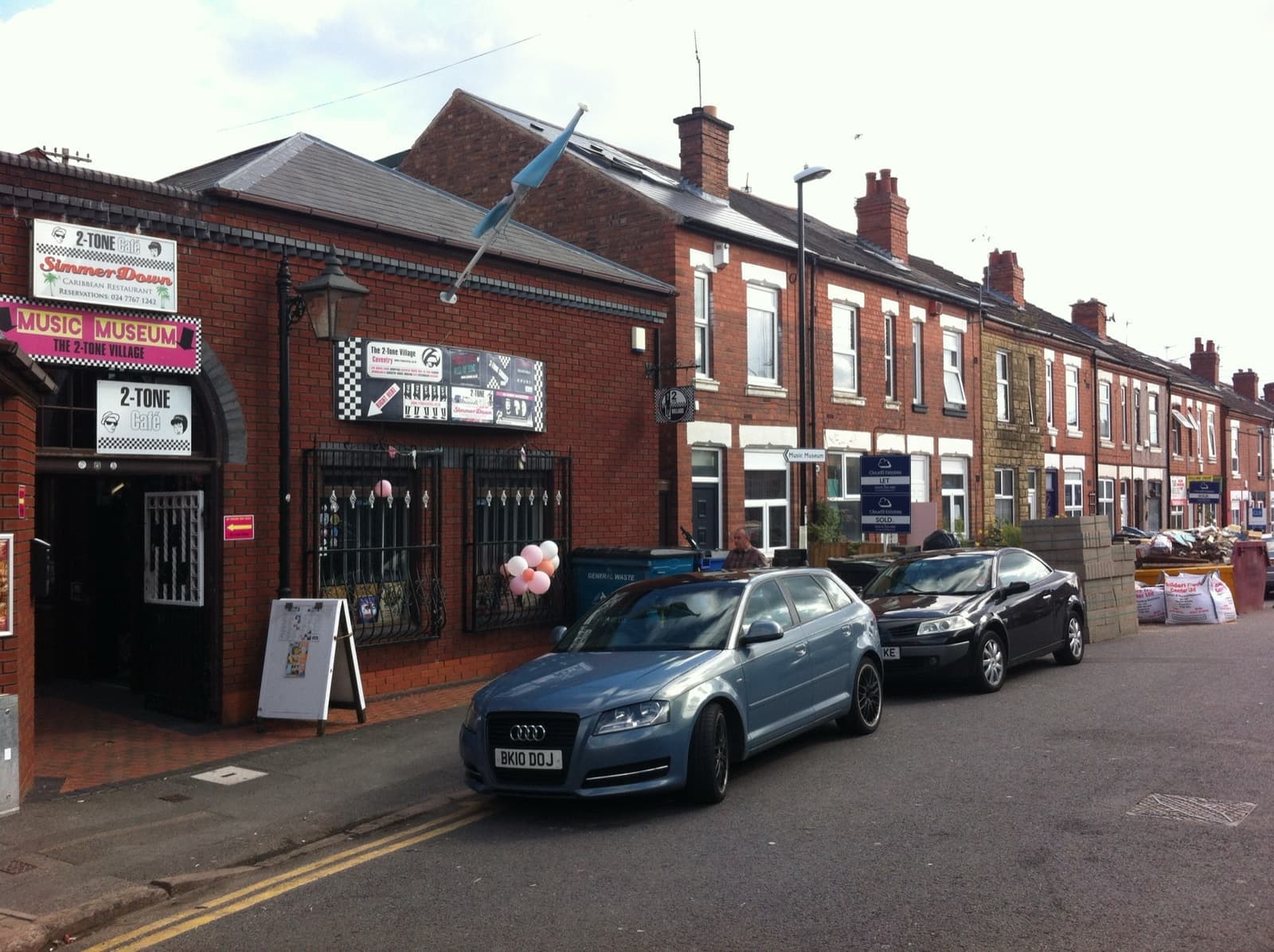 A brick corner building with music museum signs in Coventry
