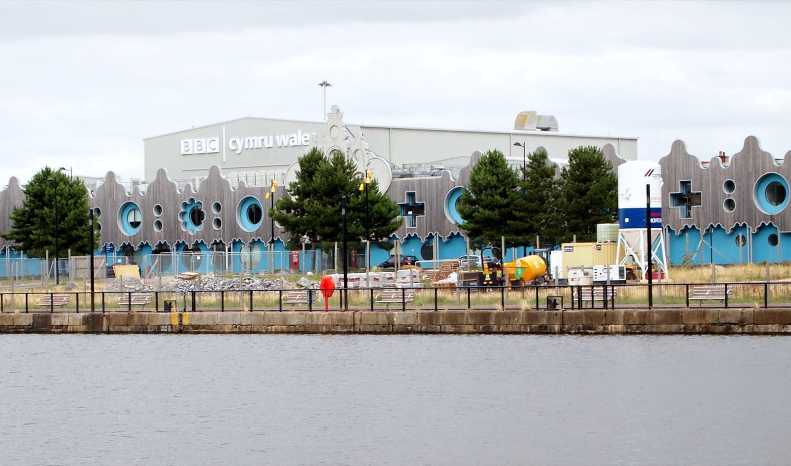 A long studio building on the far side of a dock
