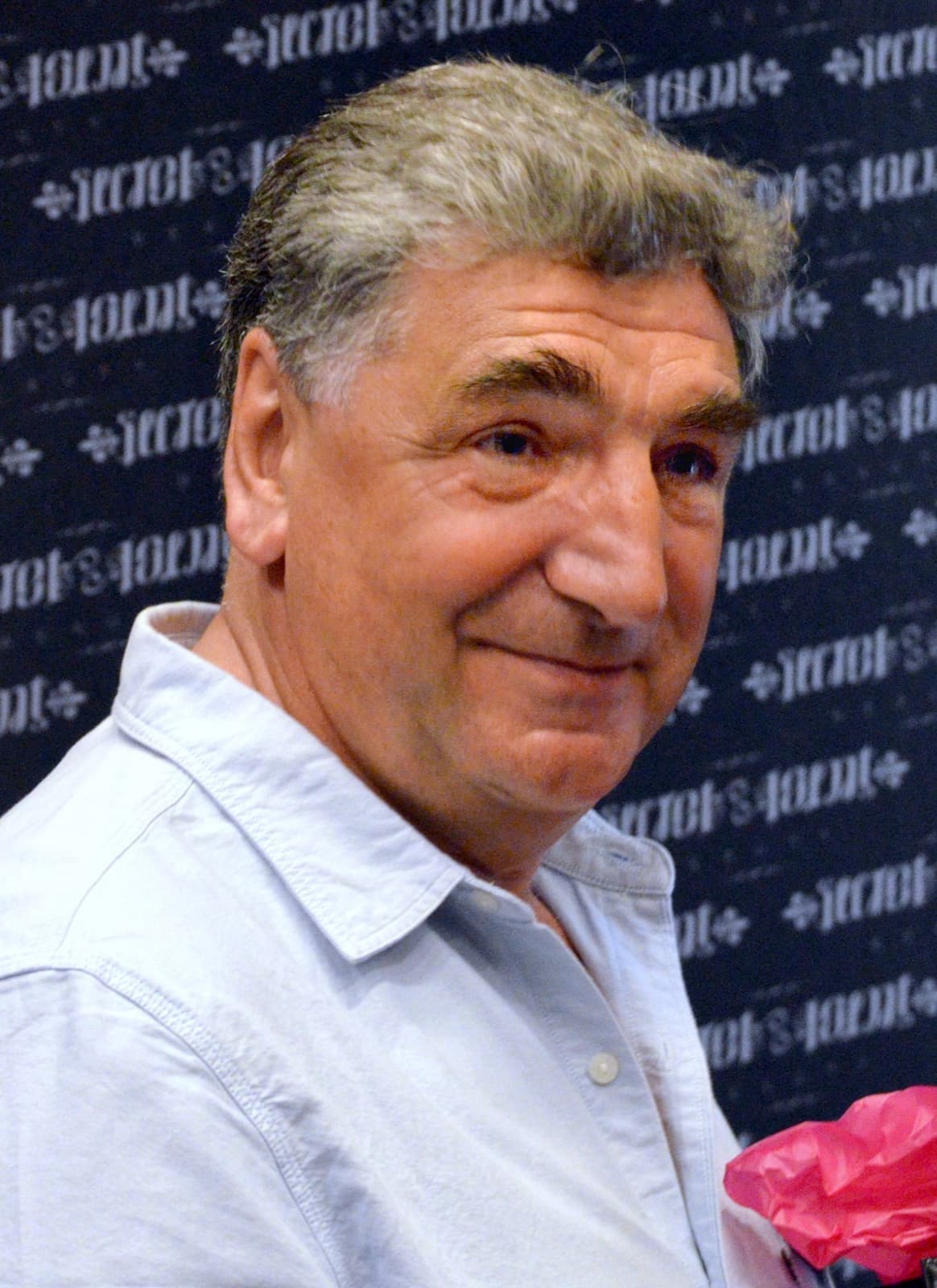 Jim Carter smiling, in a dark jacket