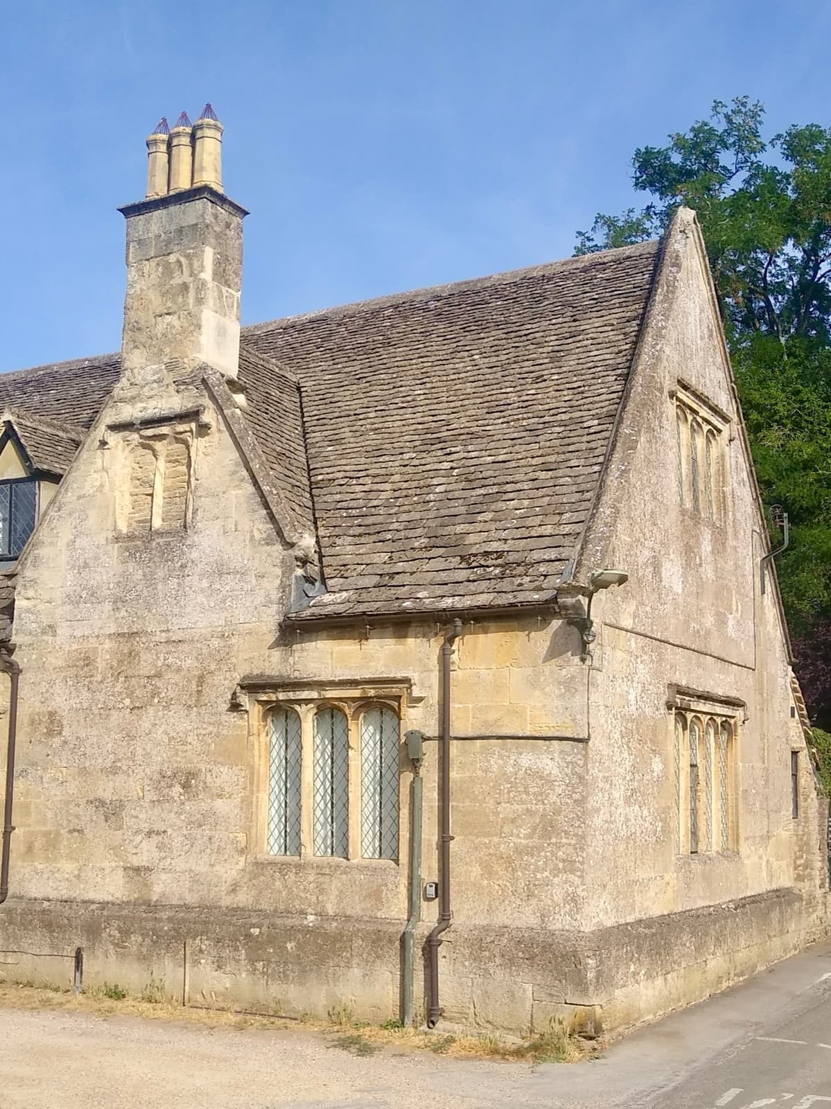 A small stone building with mullioned windows on Church View