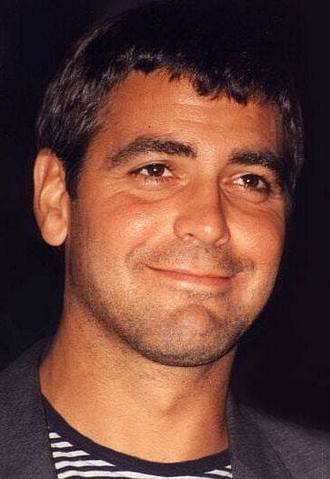 George Clooney in 1995, smiling, in a striped shirt