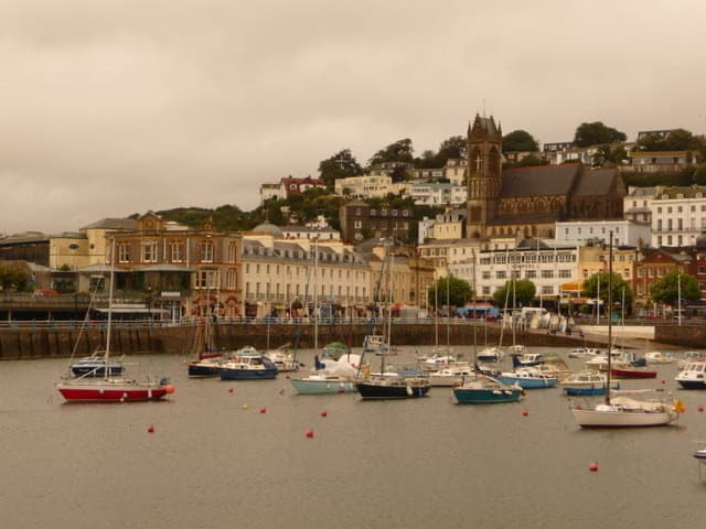 Boats in Torquay harbour with the buildings of Vaughan Parade behind