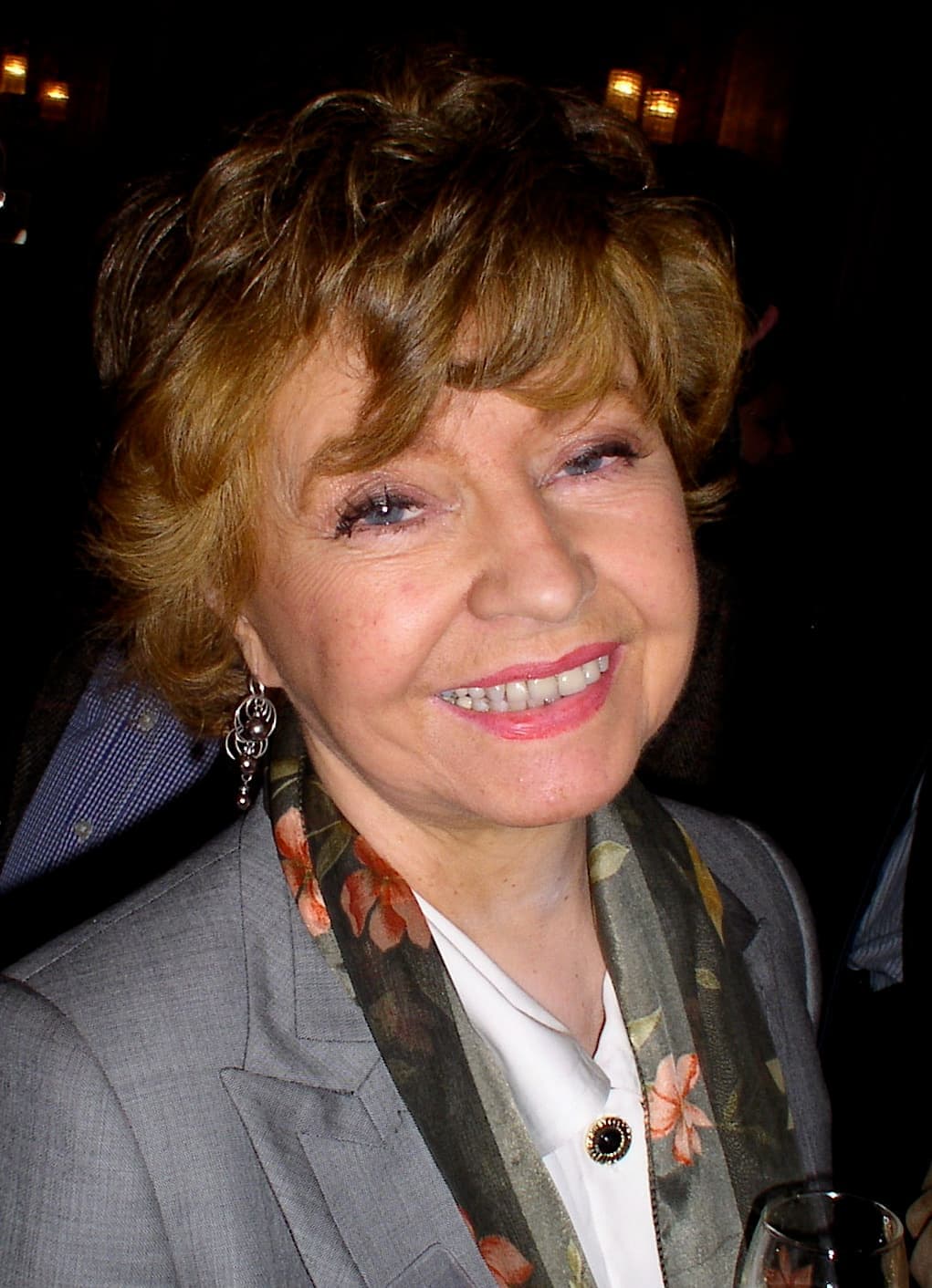 Prunella Scales smiling at a party