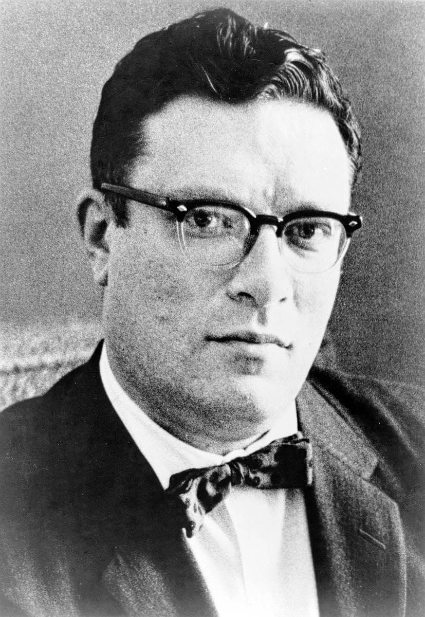 Head-and-shoulders portrait of a man with dark hair and thick sideburns