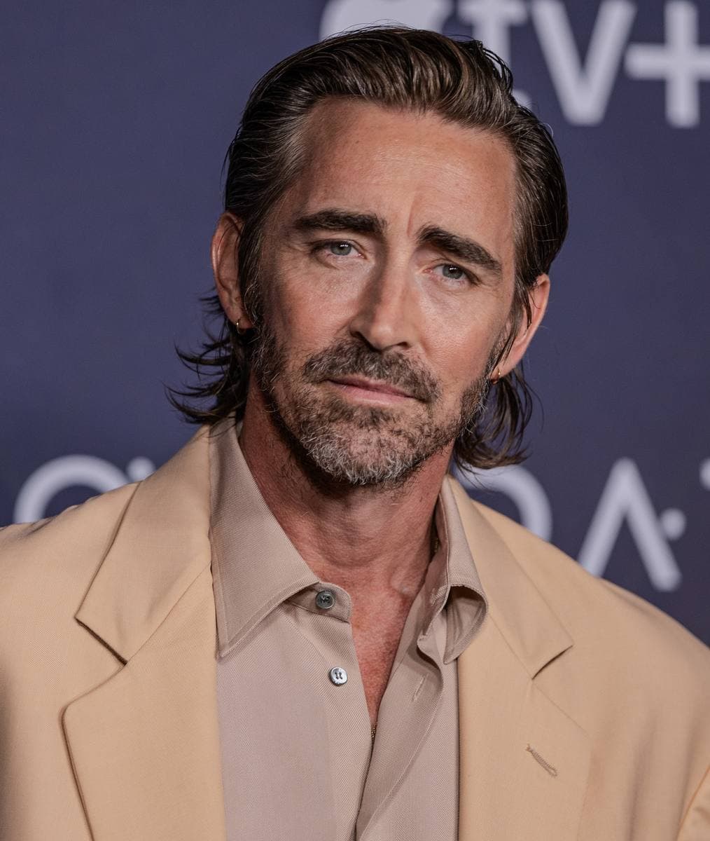 A tall dark-haired man in a suit