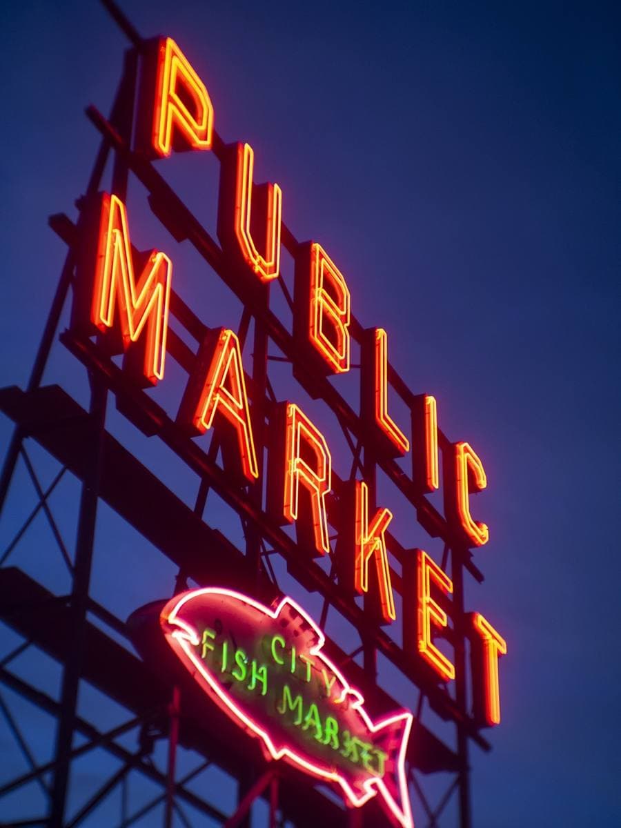 The red Public Market Center sign and clock above Pike Place