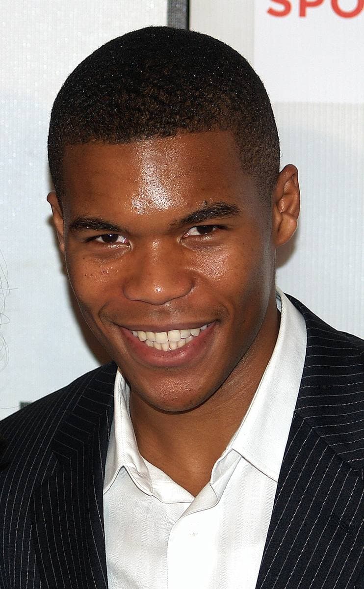 Gaius Charles in a suit at a film premiere