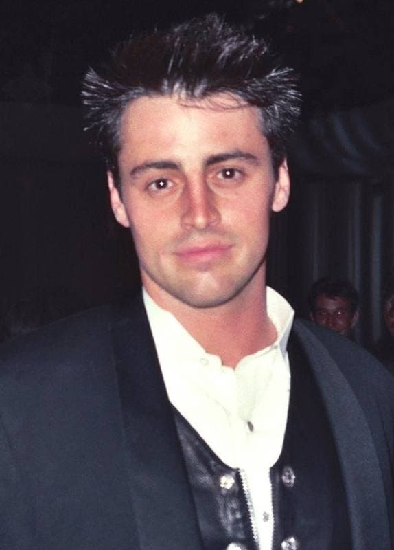 Matt LeBlanc with spiky dark hair in a dark jacket and collarless shirt