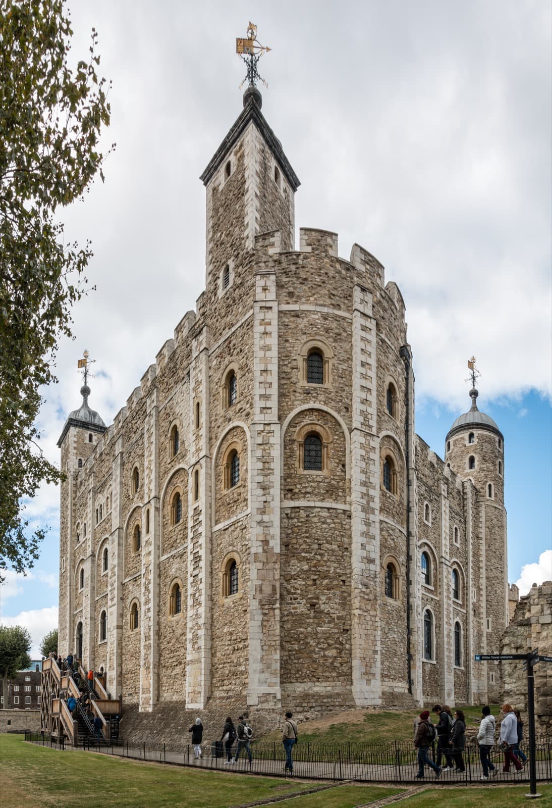 A square Norman keep of pale stone with four corner turrets