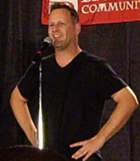 Dave Coulier smiling, in a casual shirt