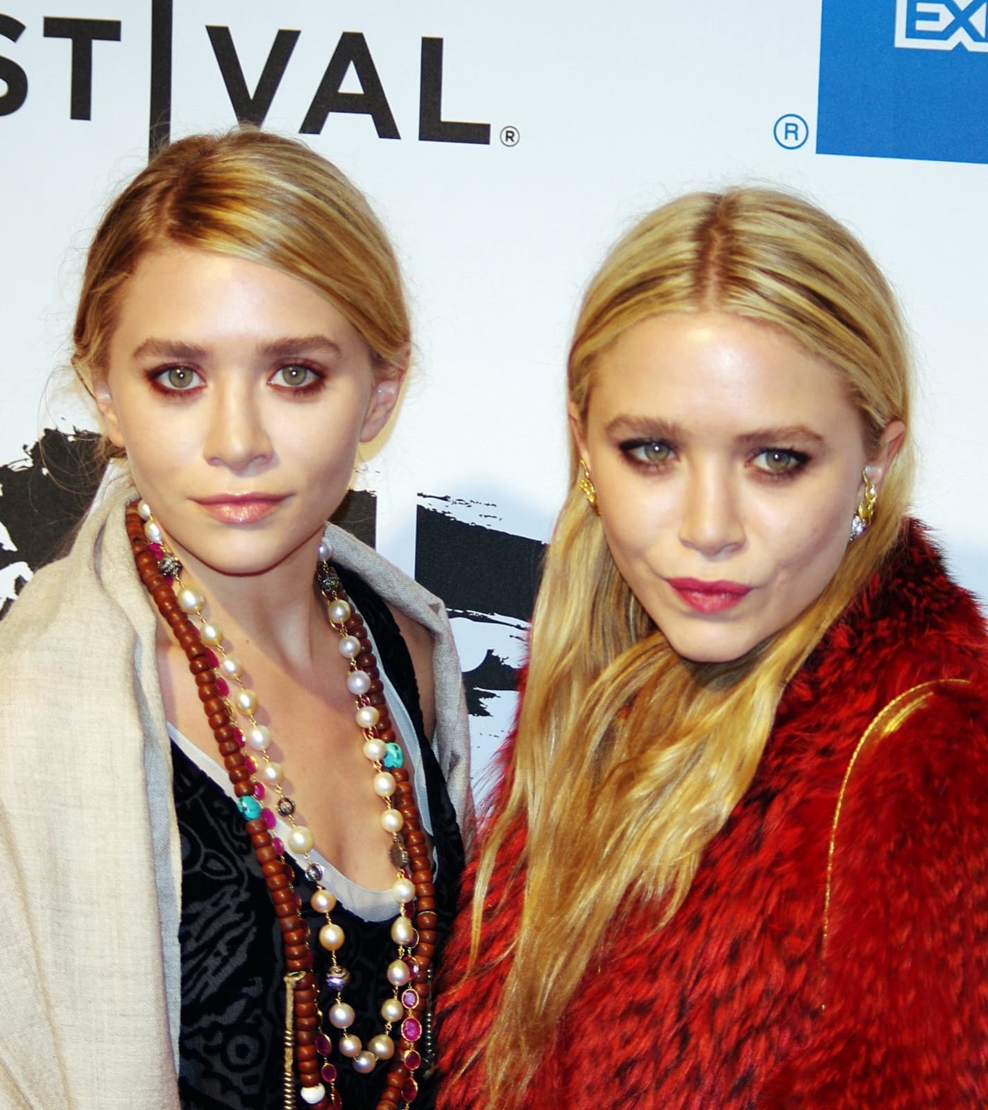 Ashley and Mary-Kate Olsen standing together at a premiere