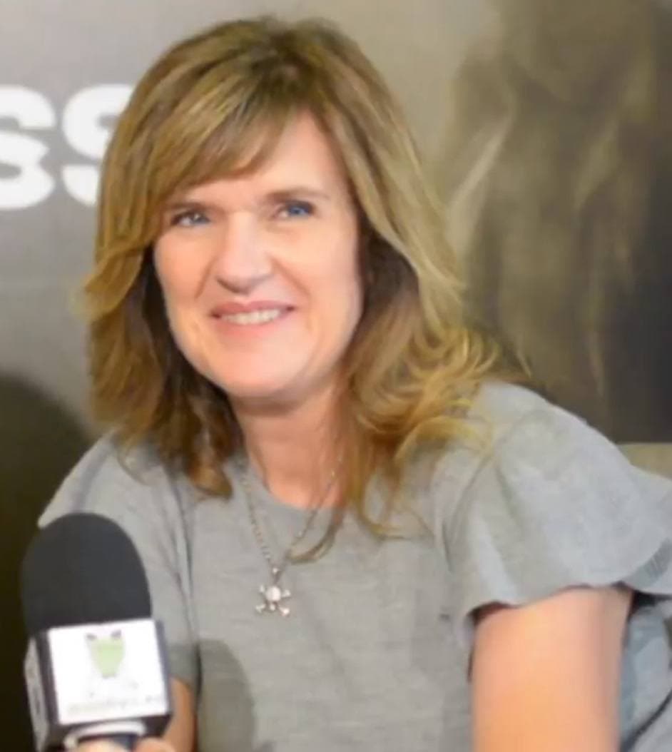 Siobhan Finneran in a grey top, smiling at an interviewer’s microphone