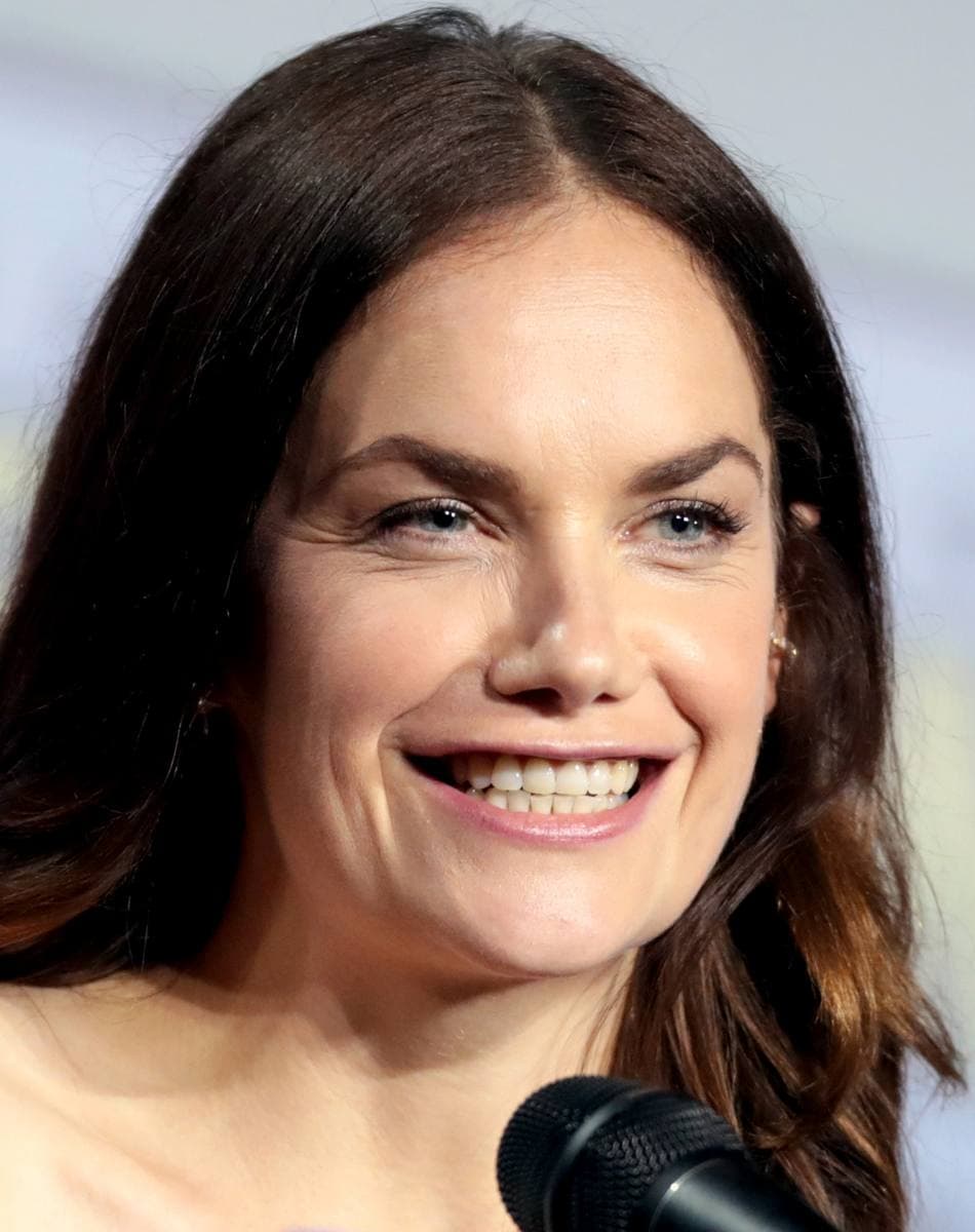A woman with dark hair speaking into a microphone