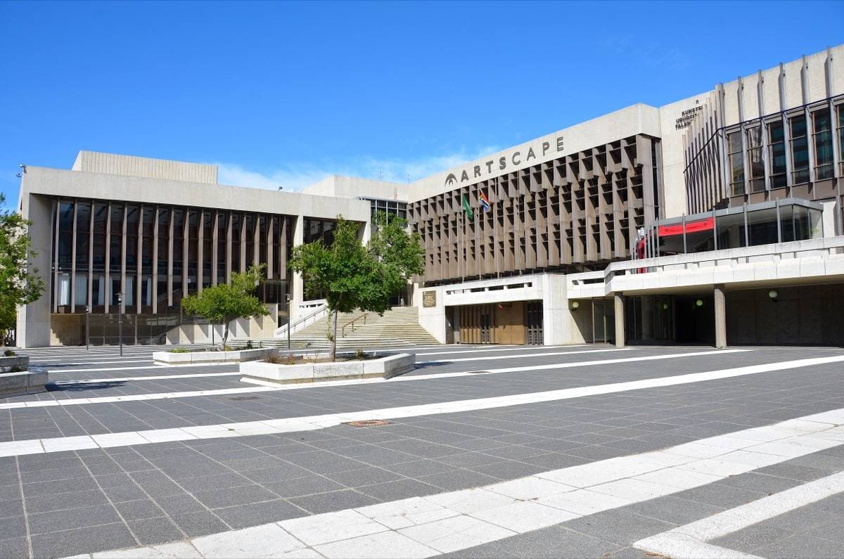 A 1970s concrete arts complex with a forecourt