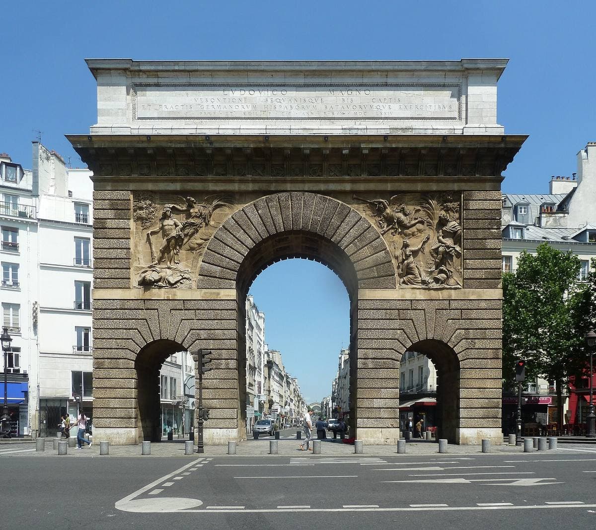A stone triumphal arch at the end of a street