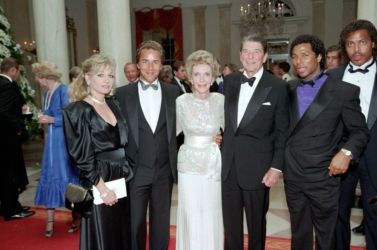 Five people in evening dress in the White House Cross Hall
