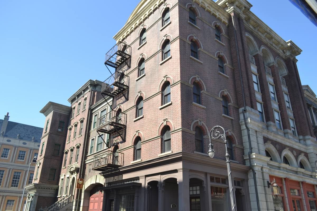 Brick facades of a backlot street with fire escapes