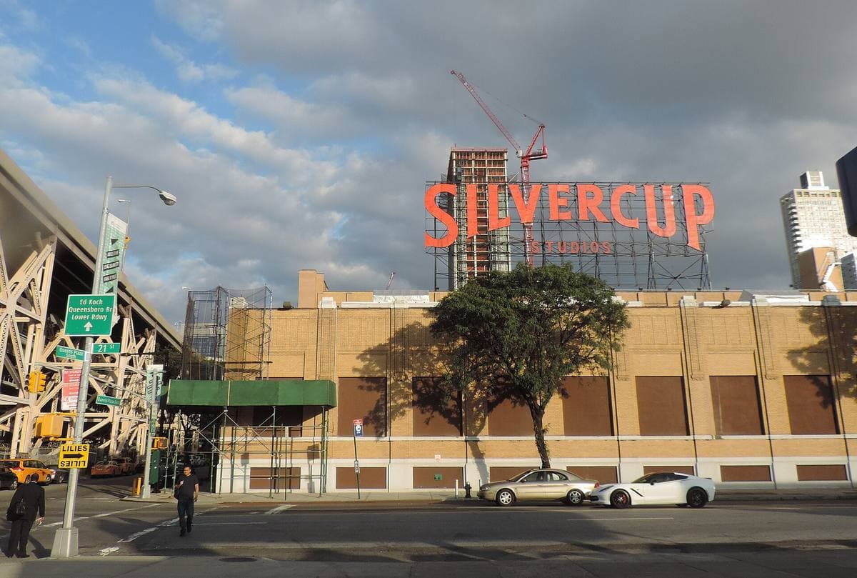 A brick studio building with a large red Silvercup sign on its roof