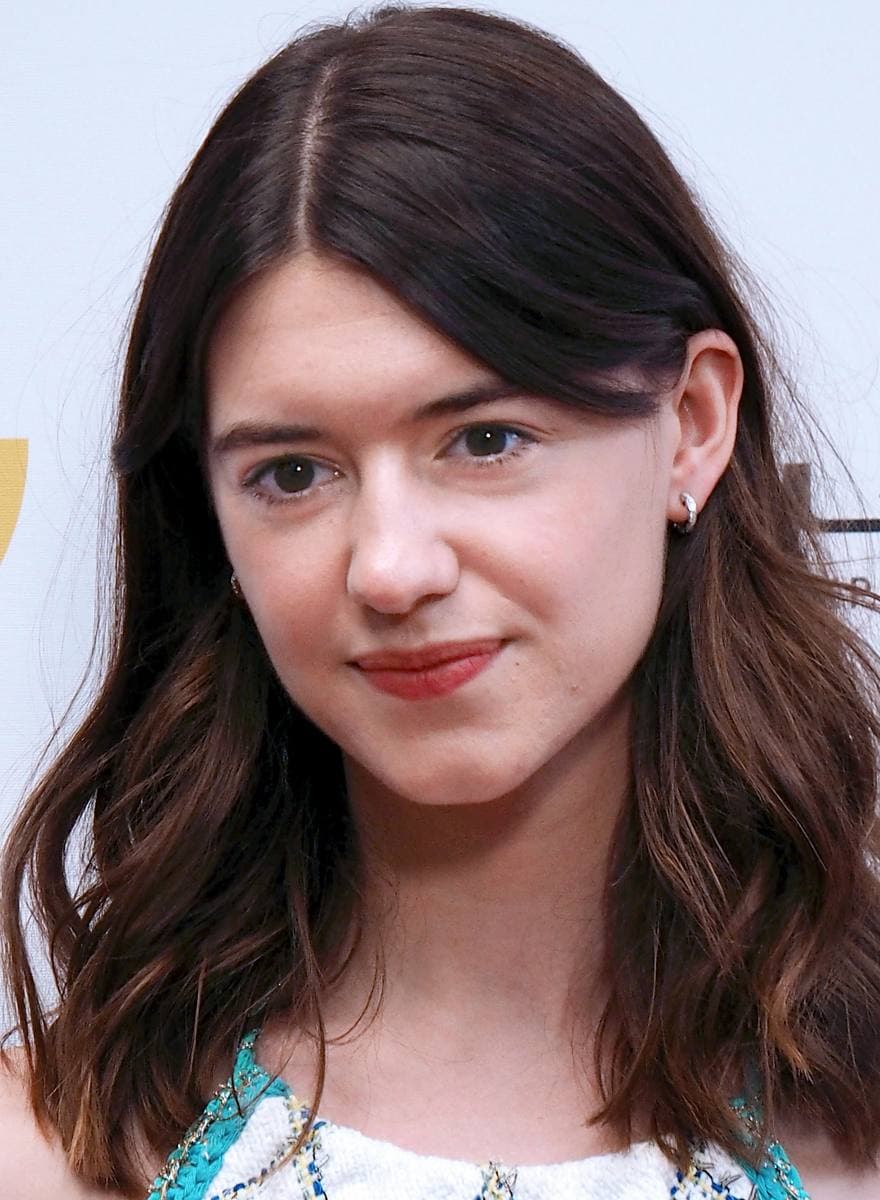 Daisy Edgar-Jones with long dark hair, smiling slightly