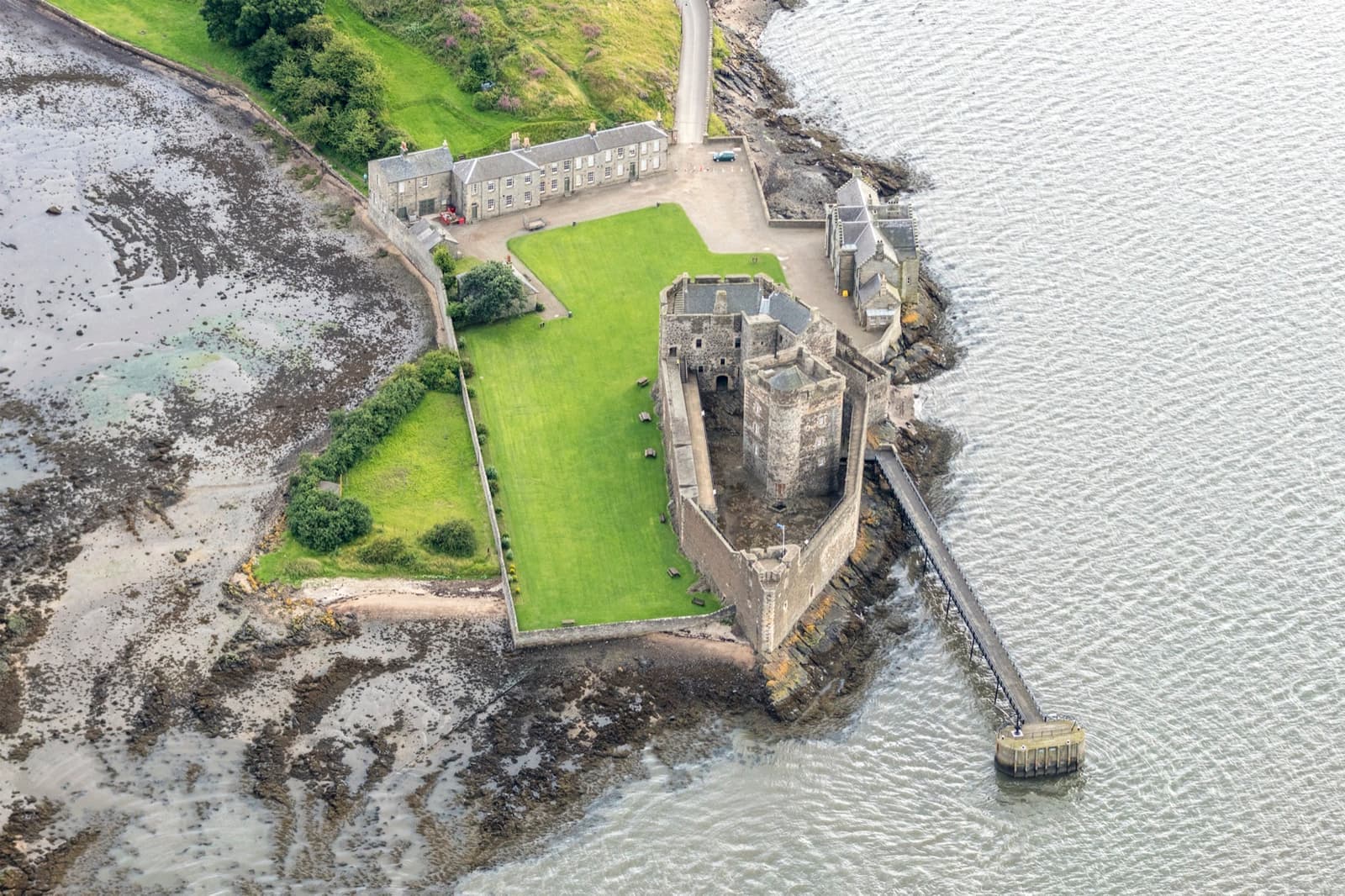 Aerial view of Blackness Castle on a rocky point in the Forth, shaped like a ship