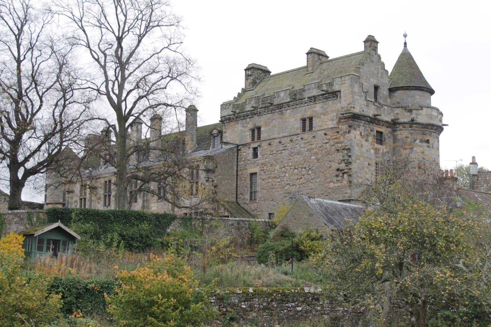 The stone towers and wings of Falkland Palace above its garden