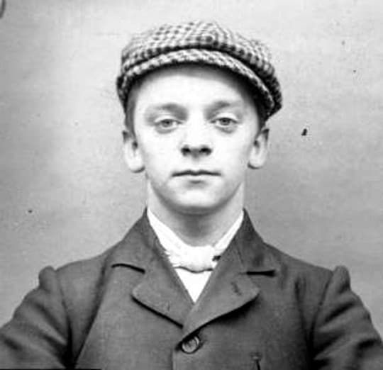 A young man in a flat cap and jacket in a black-and-white police photograph