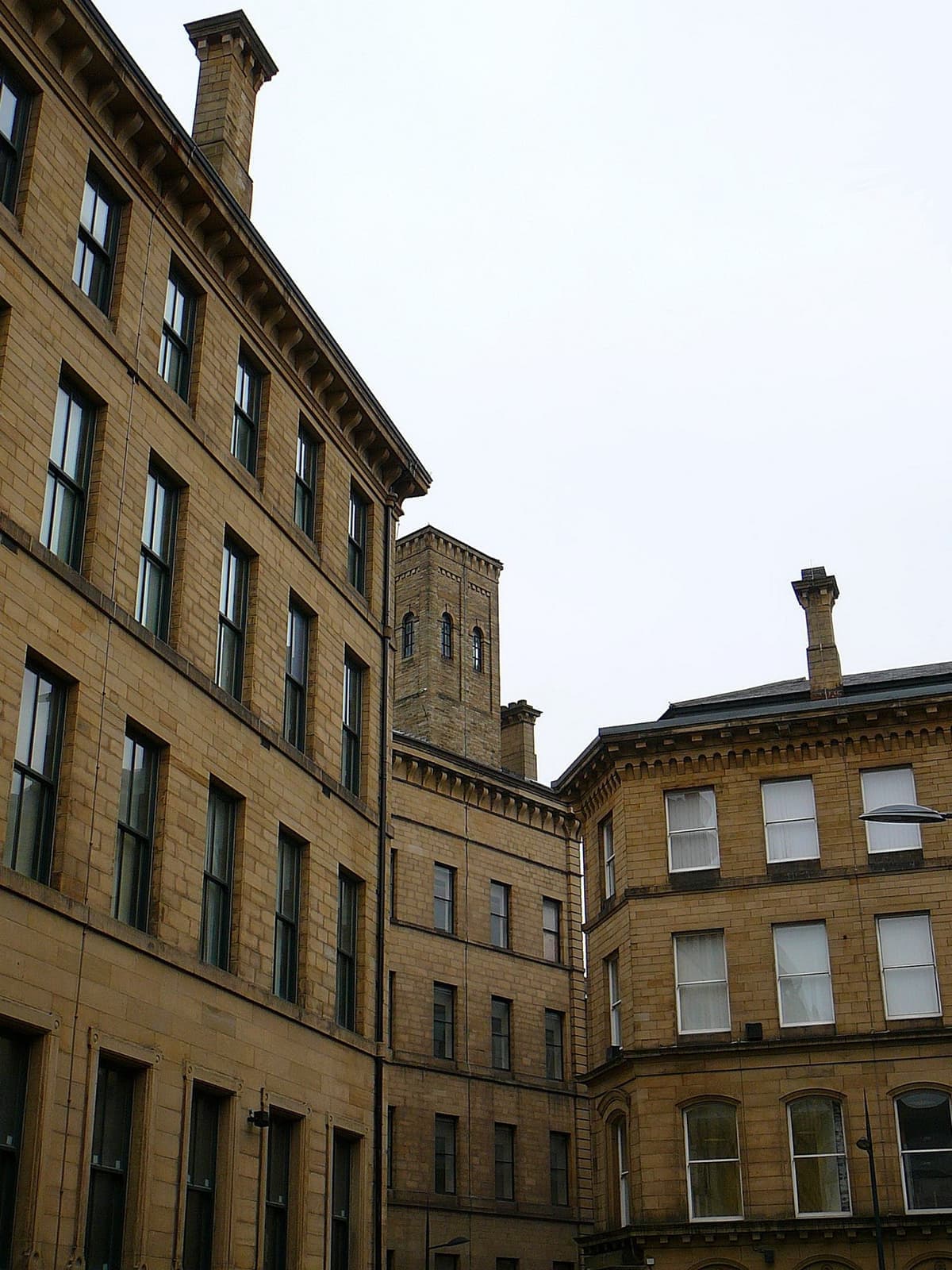 Tall stone warehouses facing each other across a narrow street