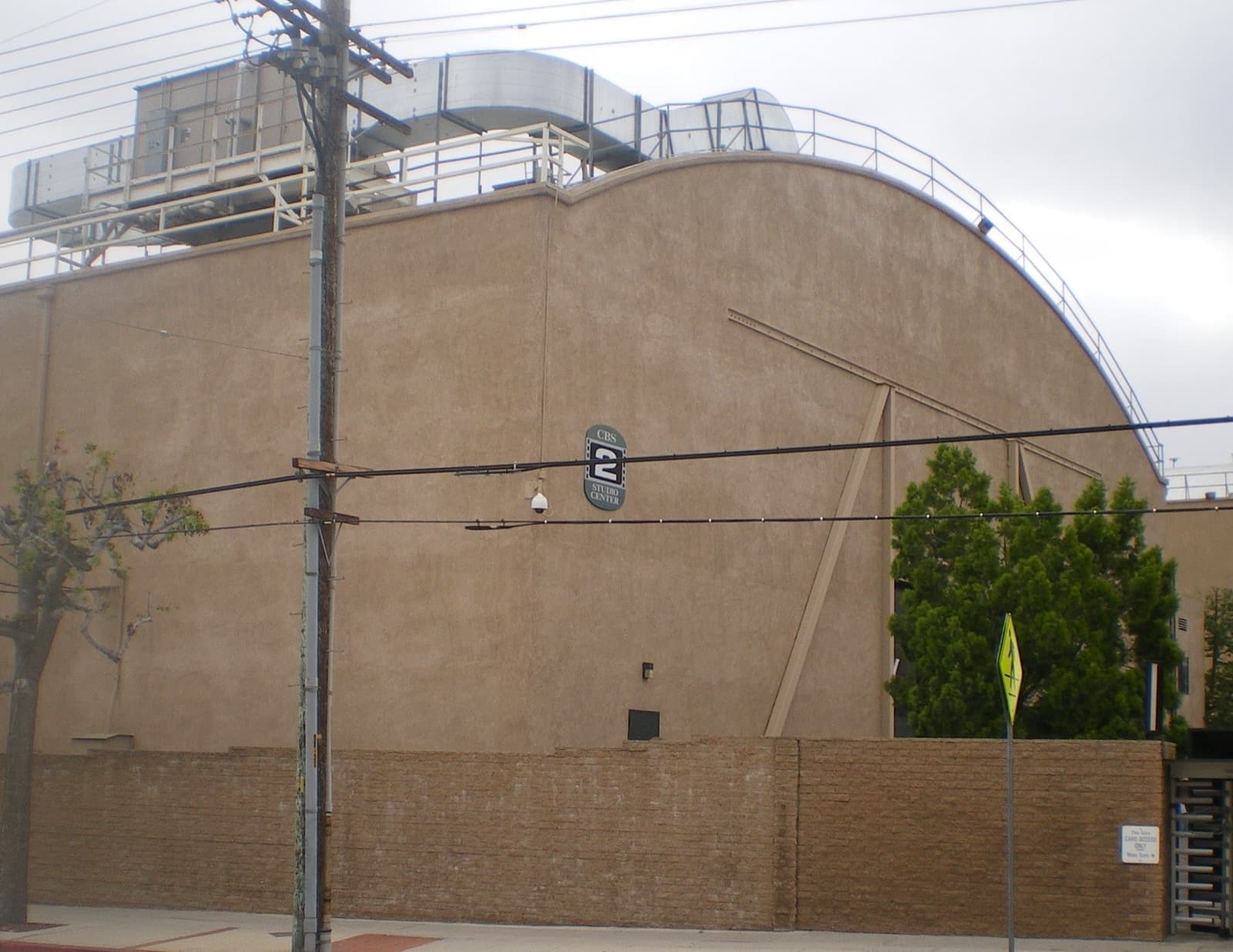 A tall cream soundstage wall with a stage number on the studio lot