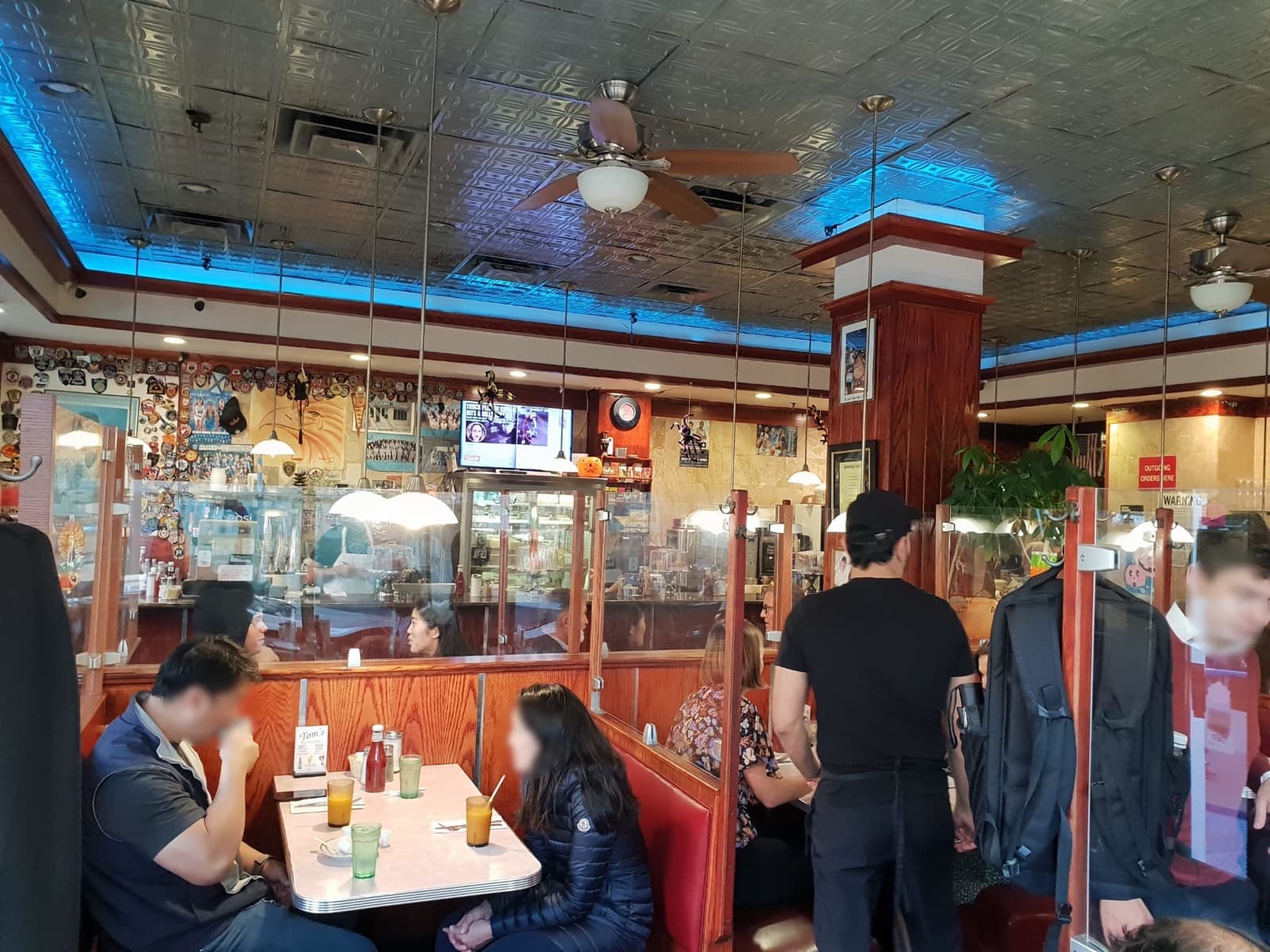 Booths and a counter inside the diner at 2880 Broadway