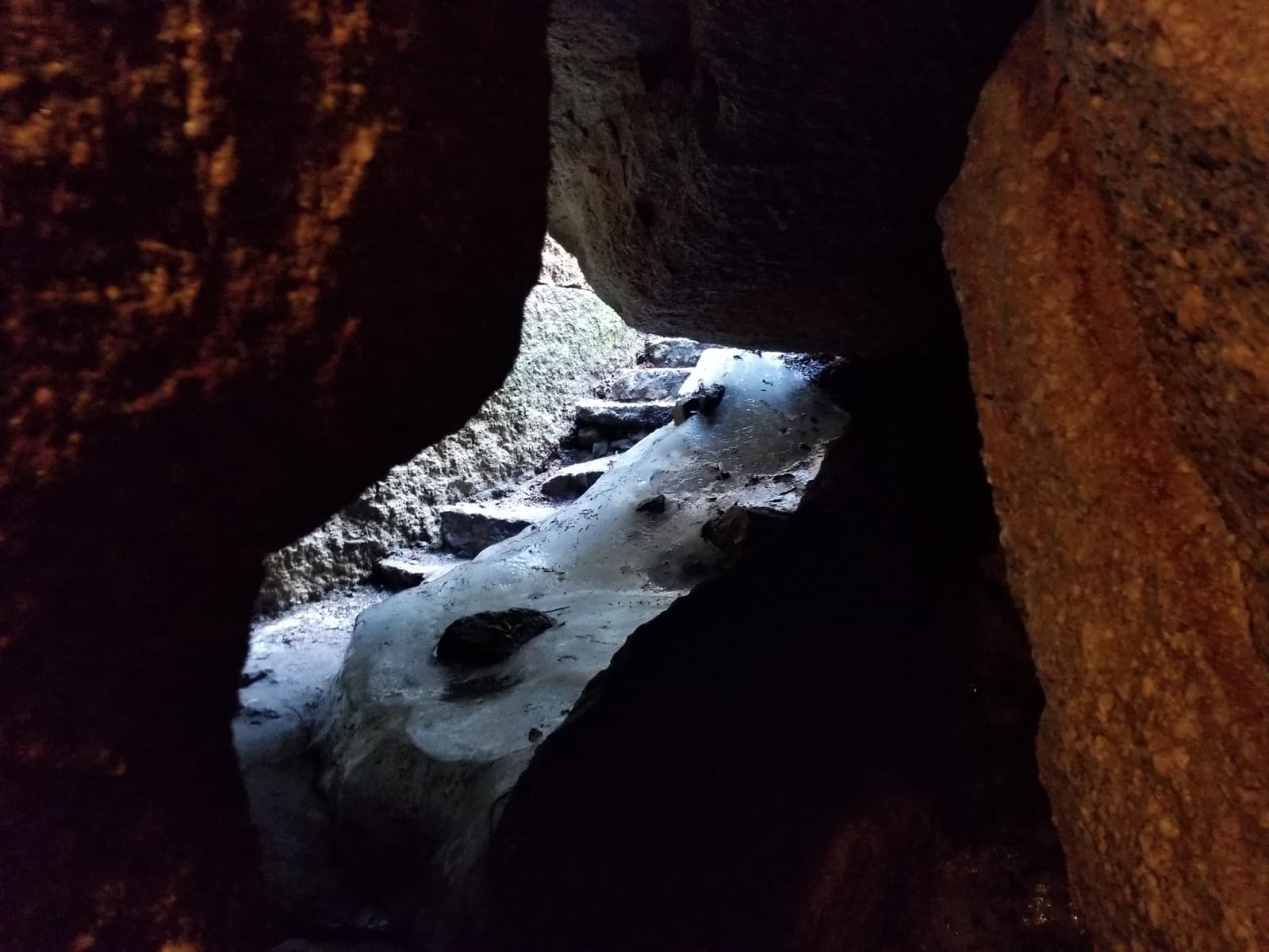 Ice and snow lying in a dark rock crevice