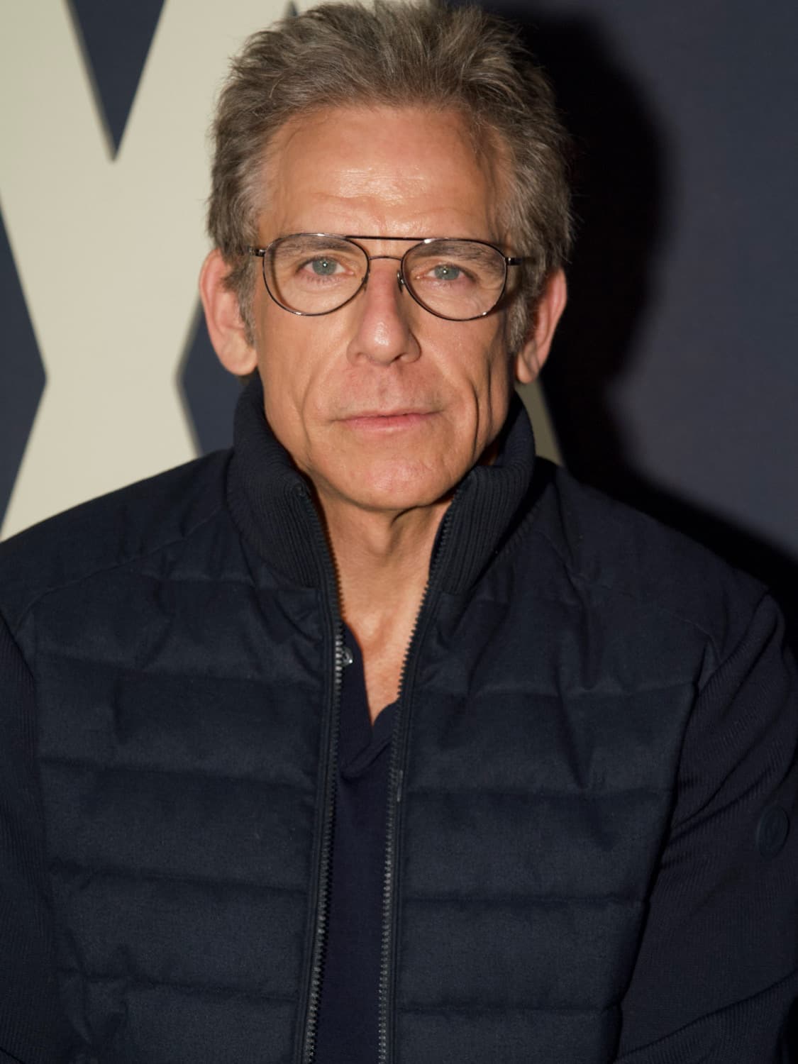 Ben Stiller in glasses and a dark padded jacket
