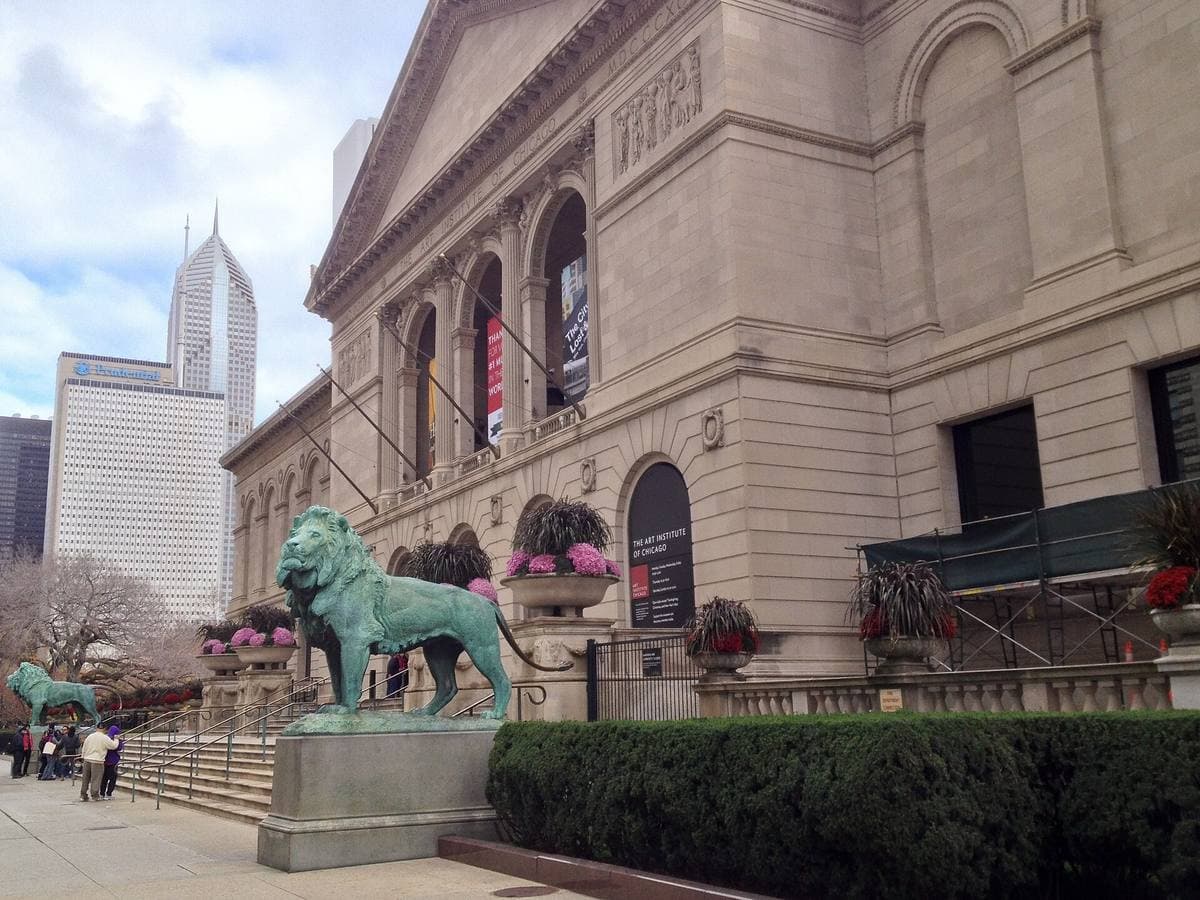 The Art Institute's stone facade on Michigan Avenue with a bronze lion