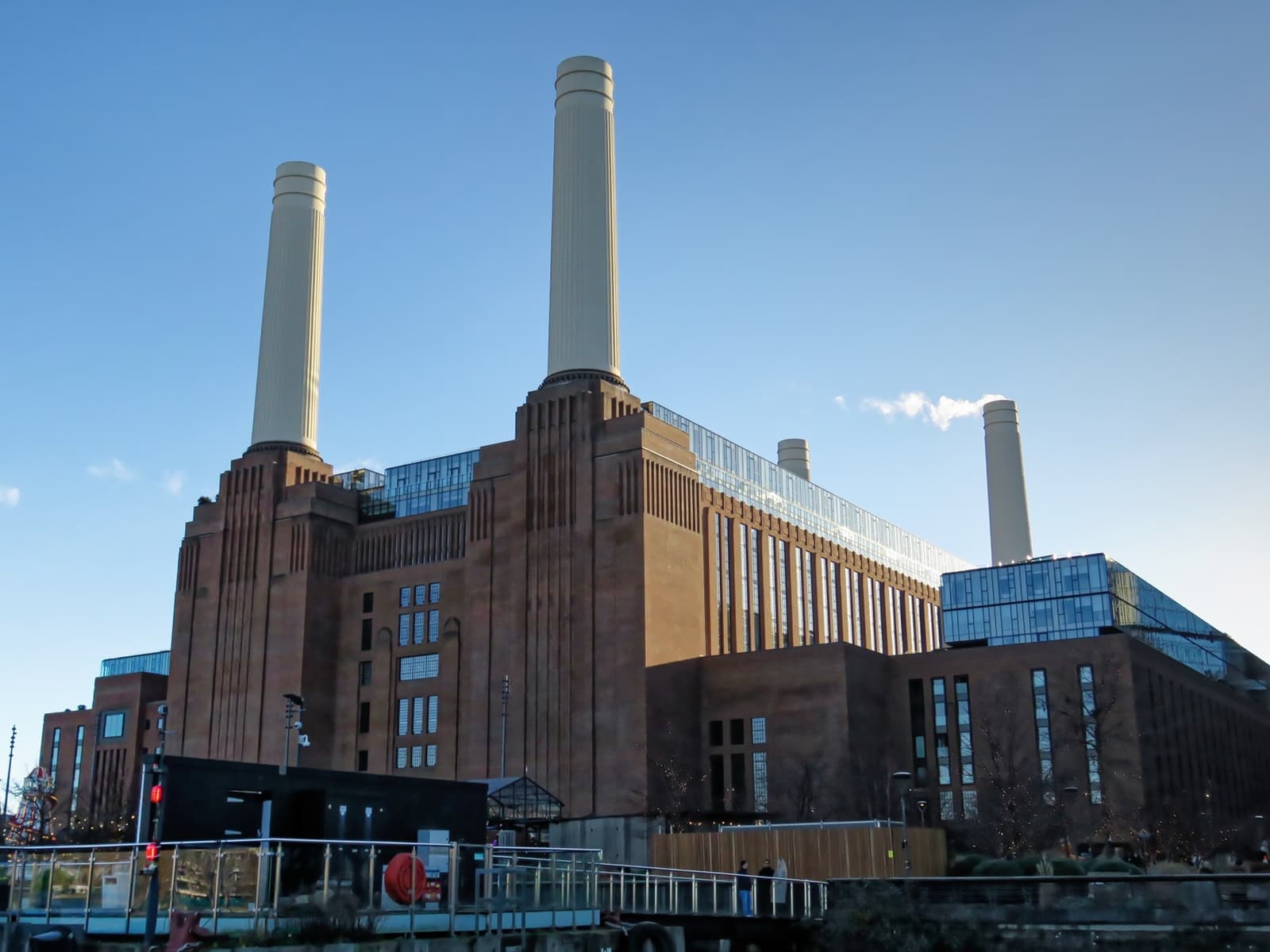 Battersea Power Station’s brick bulk and four white chimneys seen from the river