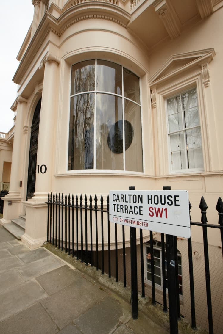 The cream stucco corner of 10 Carlton House Terrace with its street sign and railings