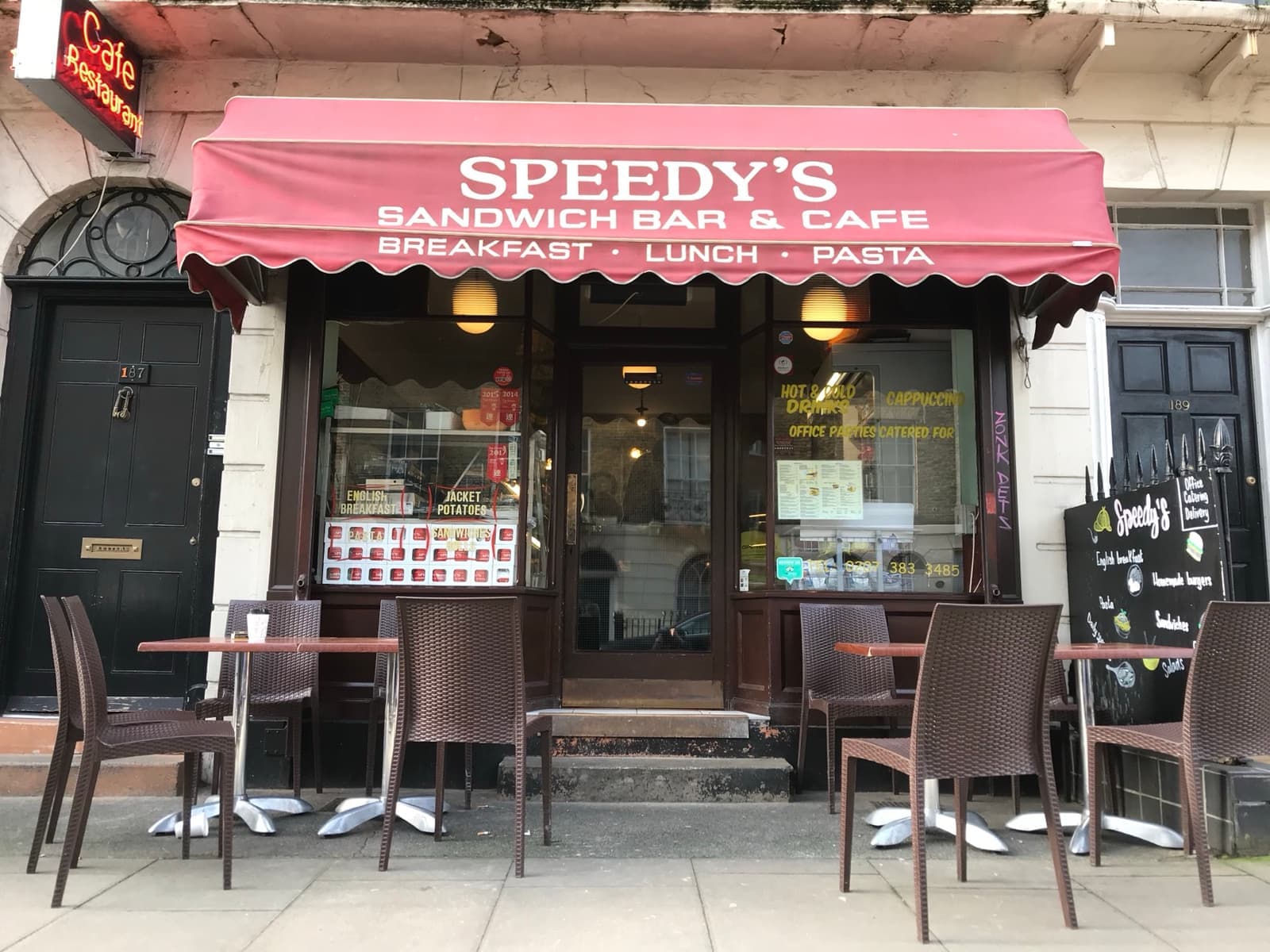 Speedy’s Sandwich Bar & Cafe with its maroon awning, the black front door beside it