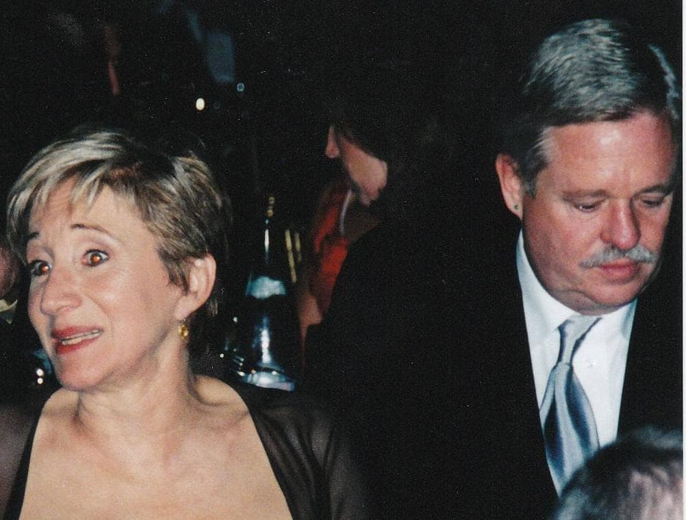 Olympia Dukakis, short fair hair and a black dress, beside Armistead Maupin in a suit and silver tie
