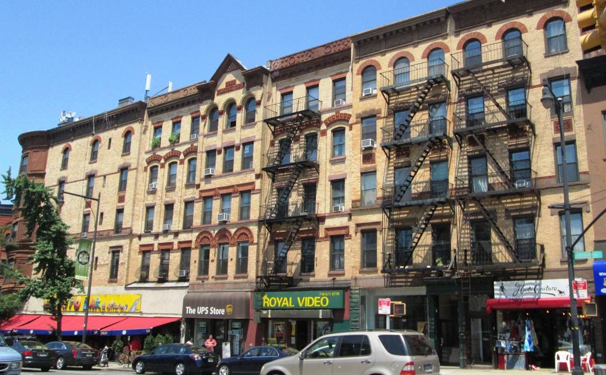 Brick row buildings with shops on a street corner